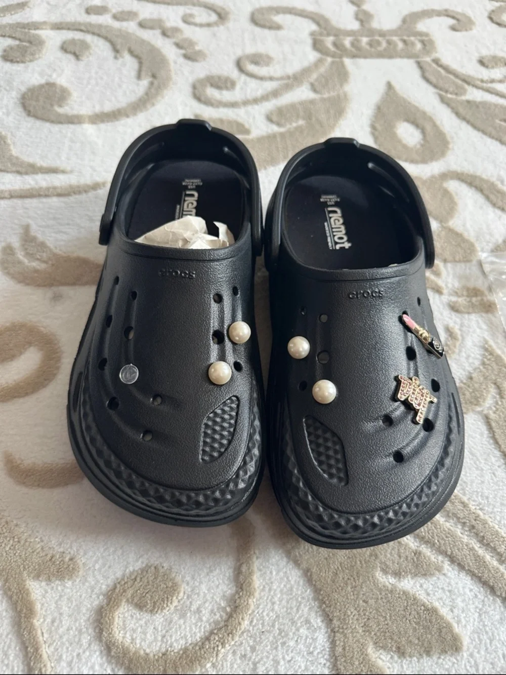 Women’s black Crocs with extra inserts and homemade charms